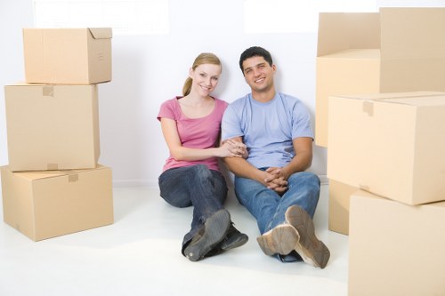 Professional movers handling furniture inside a Hadley Wood home