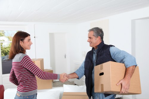 Professional removals crew handling household items with care