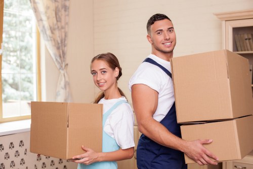 Team preparing for an office relocation with labelled boxes and furniture handling